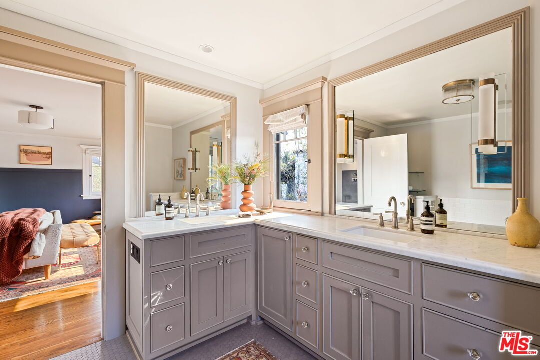 375 North Ridgewood Place Los Angeles, CA 90004 - Photo 30 of 56 a bathroom with a sink double vanity granite and a mirror