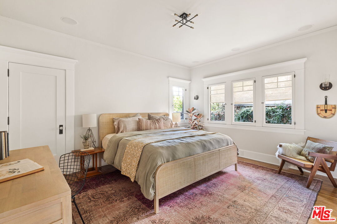 375 North Ridgewood Place Los Angeles, CA 90004 - Photo 33 of 56 a bedroom with a bed and a couch