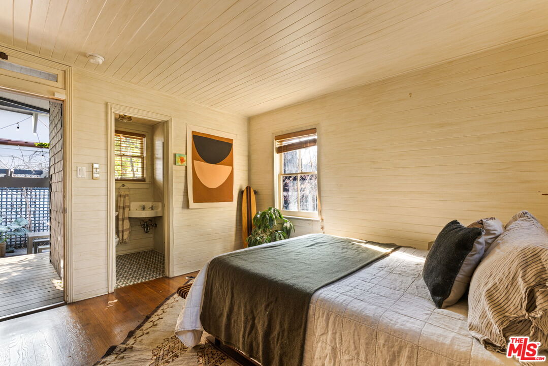 375 North Ridgewood Place Los Angeles, CA 90004 - Photo 40 of 56 a bedroom with a bed and wooden floor