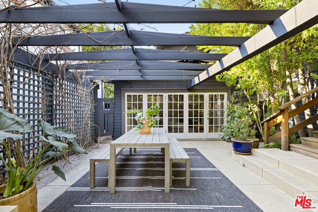 375 North Ridgewood Place Los Angeles, CA 90004 - Photo 43 of 56 a view of a patio with table and chairs and potted plants