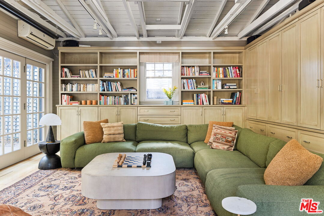 375 North Ridgewood Place Los Angeles, CA 90004 - Photo 46 of 56 a living room with furniture and a book shelf
