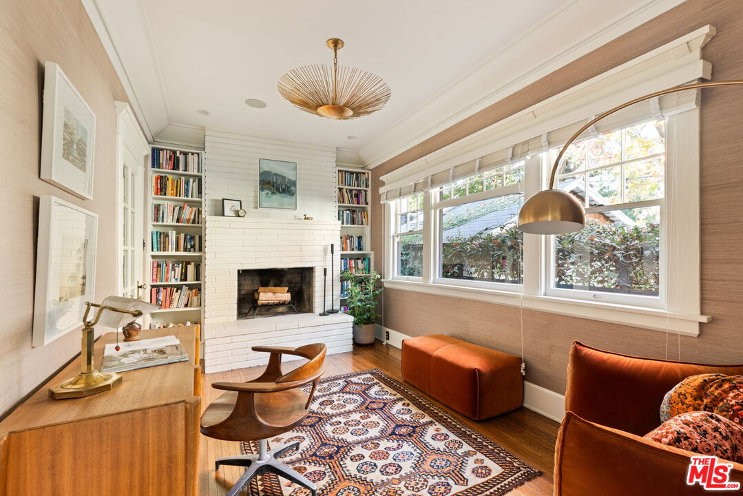 375 North Ridgewood Place Los Angeles, CA 90004 - Photo 9 of 56 a living room with furniture a chandelier and a fireplace