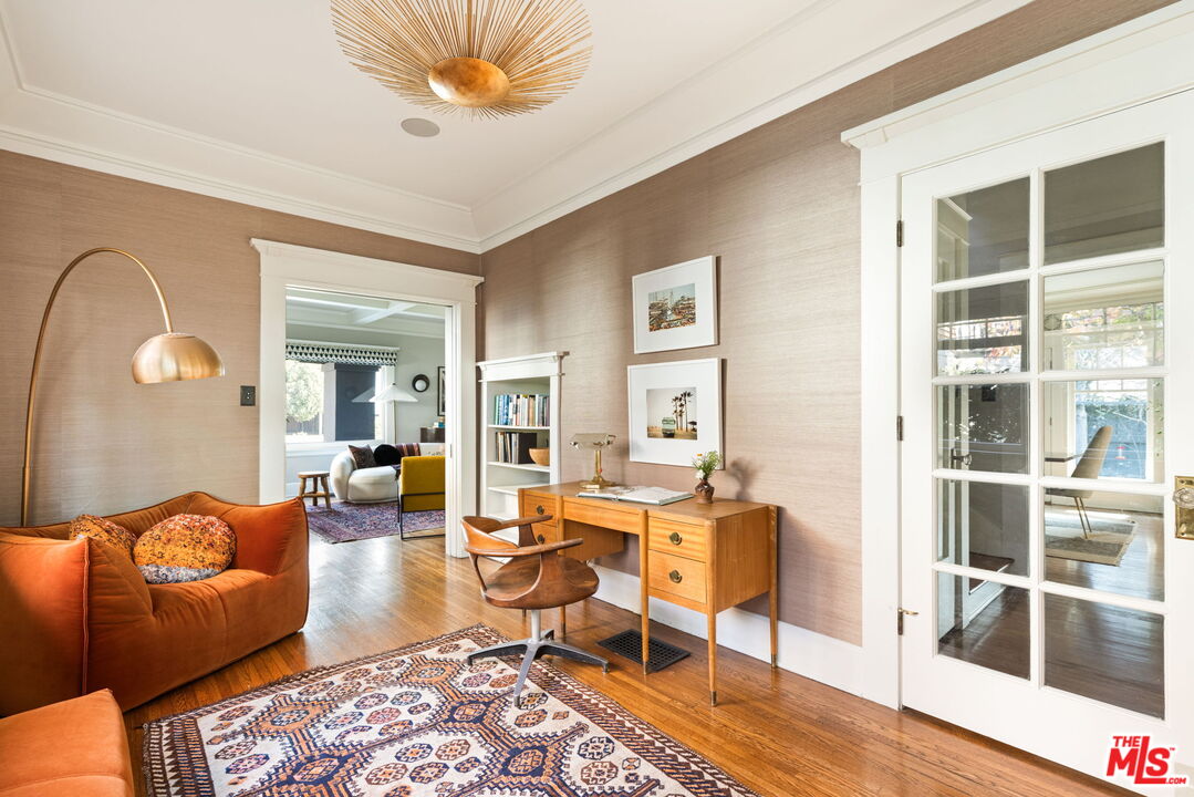375 North Ridgewood Place Los Angeles, CA 90004 - Photo 10 of 56 a living room with furniture a rug potted plant and a large window
