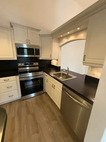 a kitchen with stainless steel appliances a stove a microwave and a refrigerator