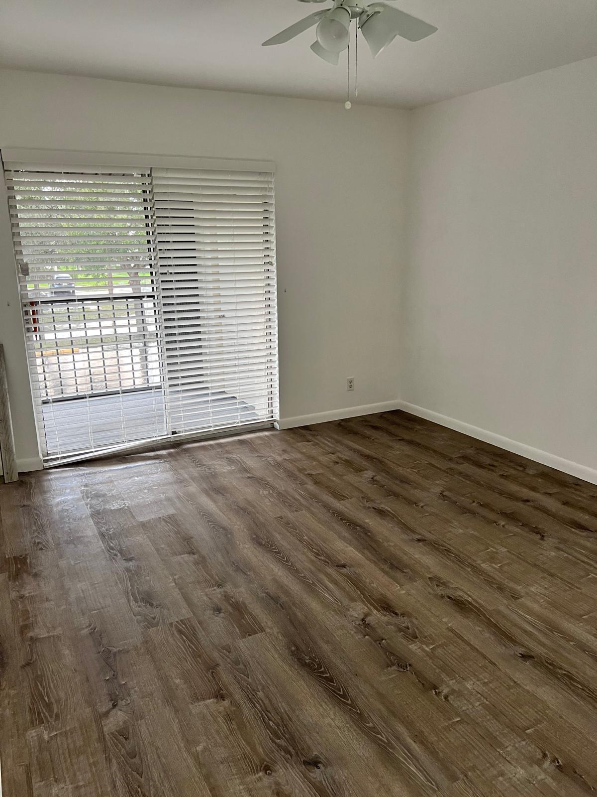6342 Chasewood Drive, Unit E Jupiter, FL 33458 - Photo 3 of 7 a view of an empty room with a window