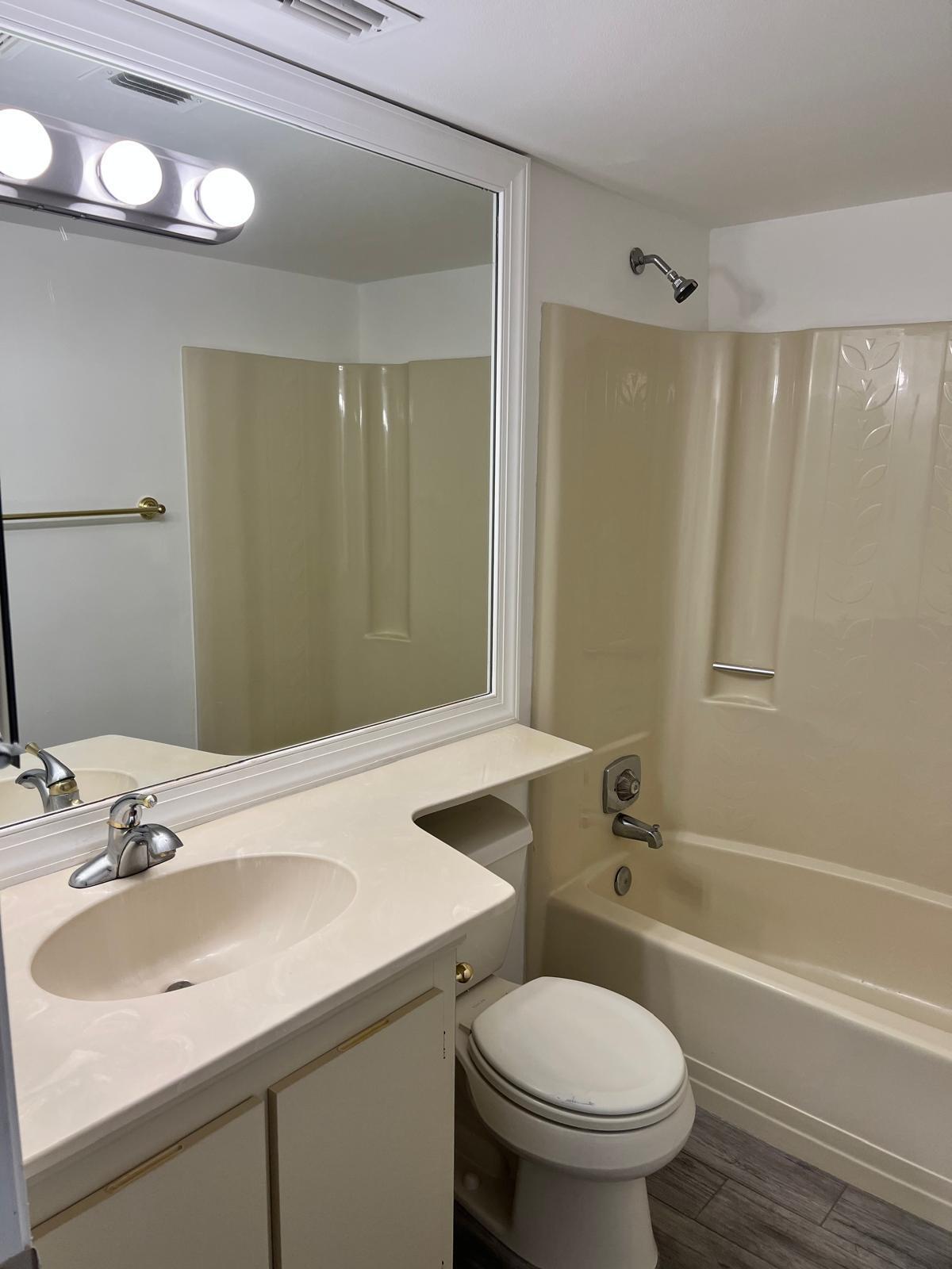 6342 Chasewood Drive, Unit E Jupiter, FL 33458 - Photo 4 of 7 a bathroom with a sink toilet and shower