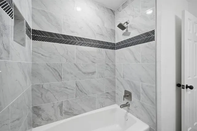 a bathroom with a shower and a shower