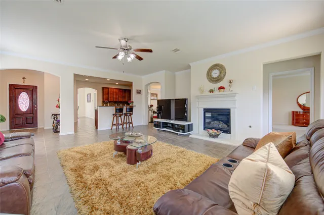 a living room with furniture a fireplace and a flat screen tv