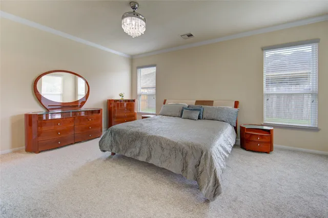 a spacious bedroom with a bed and a couch