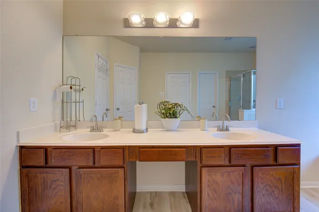 a spacious bathroom with a double vanity sink and a mirror