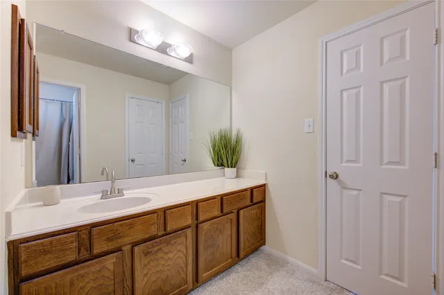 a spacious bathroom with a double vanity sink and a mirror