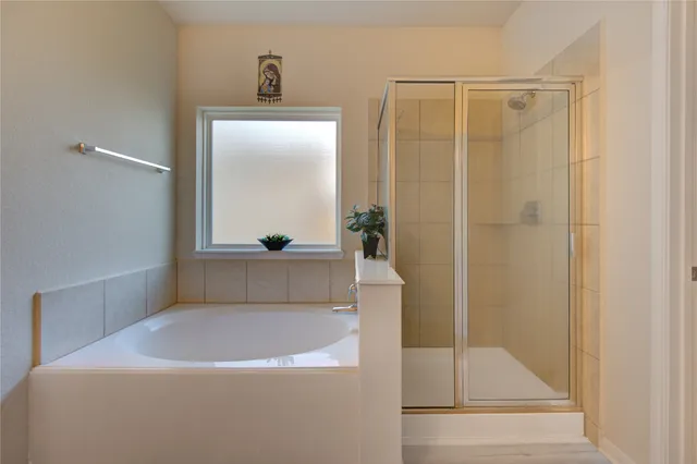 a view of walk in closet with clothes