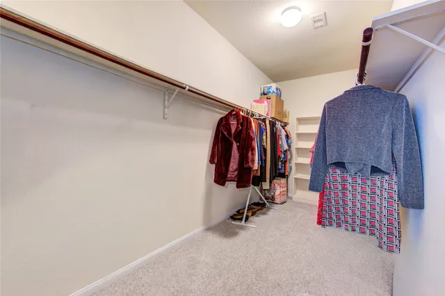 a bed room with a bed a dresser and a window