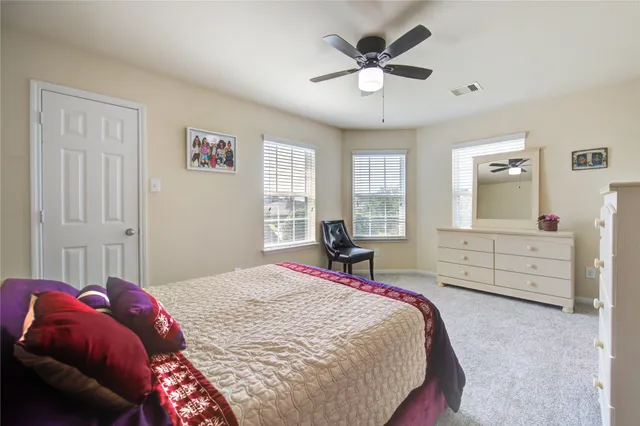 a bedroom with a bed and window