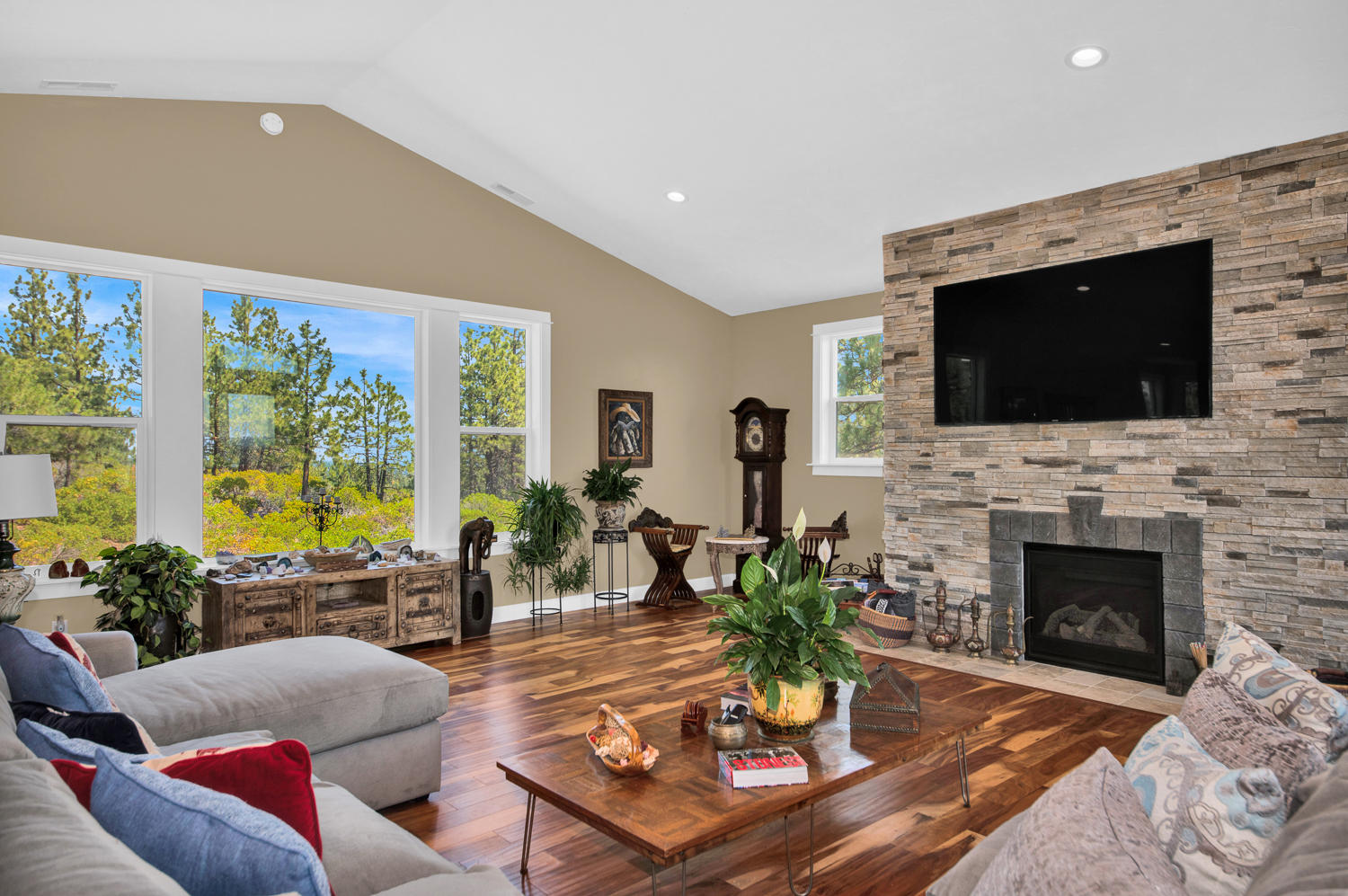 19112 Pumice Butte Road Bend, OR 97702 - Photo 11 of 36 a living room with furniture a flat screen tv and a fireplace