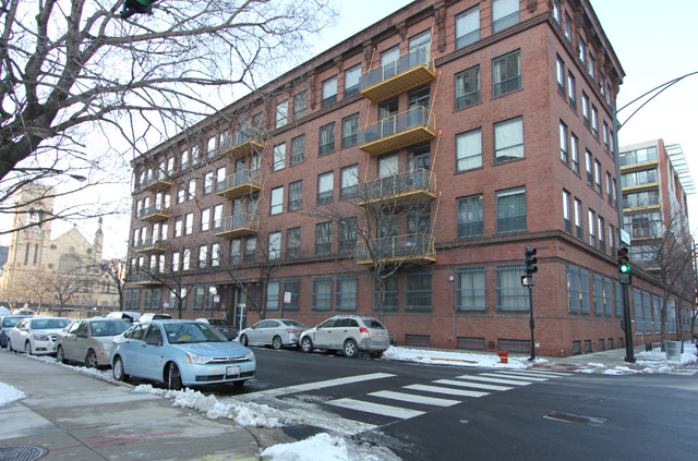 a cars parked in front of brick building