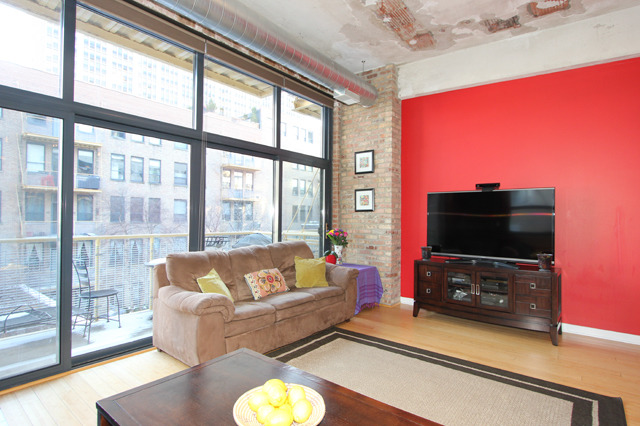 1910 South Indiana Avenue, Unit 321 Chicago, IL 60616 - Photo 2 of 25 a living room with furniture and a flat screen tv
