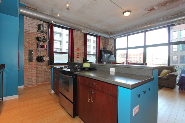 1910 South Indiana Avenue, Unit 321 Chicago, IL 60616 - Photo 7 of 25 a kitchen with stainless steel appliances granite countertop a sink a stove and a refrigerator