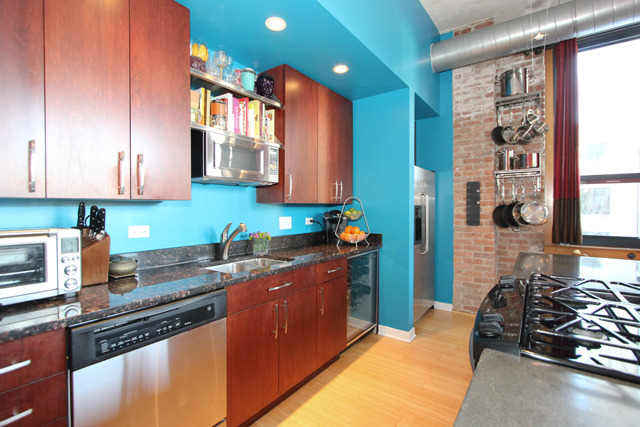 1910 South Indiana Avenue, Unit 321 Chicago, IL 60616 - Photo 8 of 25 a kitchen with stainless steel appliances granite countertop a sink stove and cabinets