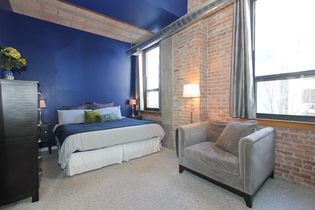 1910 South Indiana Avenue, Unit 321 Chicago, IL 60616 - Photo 10 of 25 a spacious bedroom with a bed and a couch next to a window