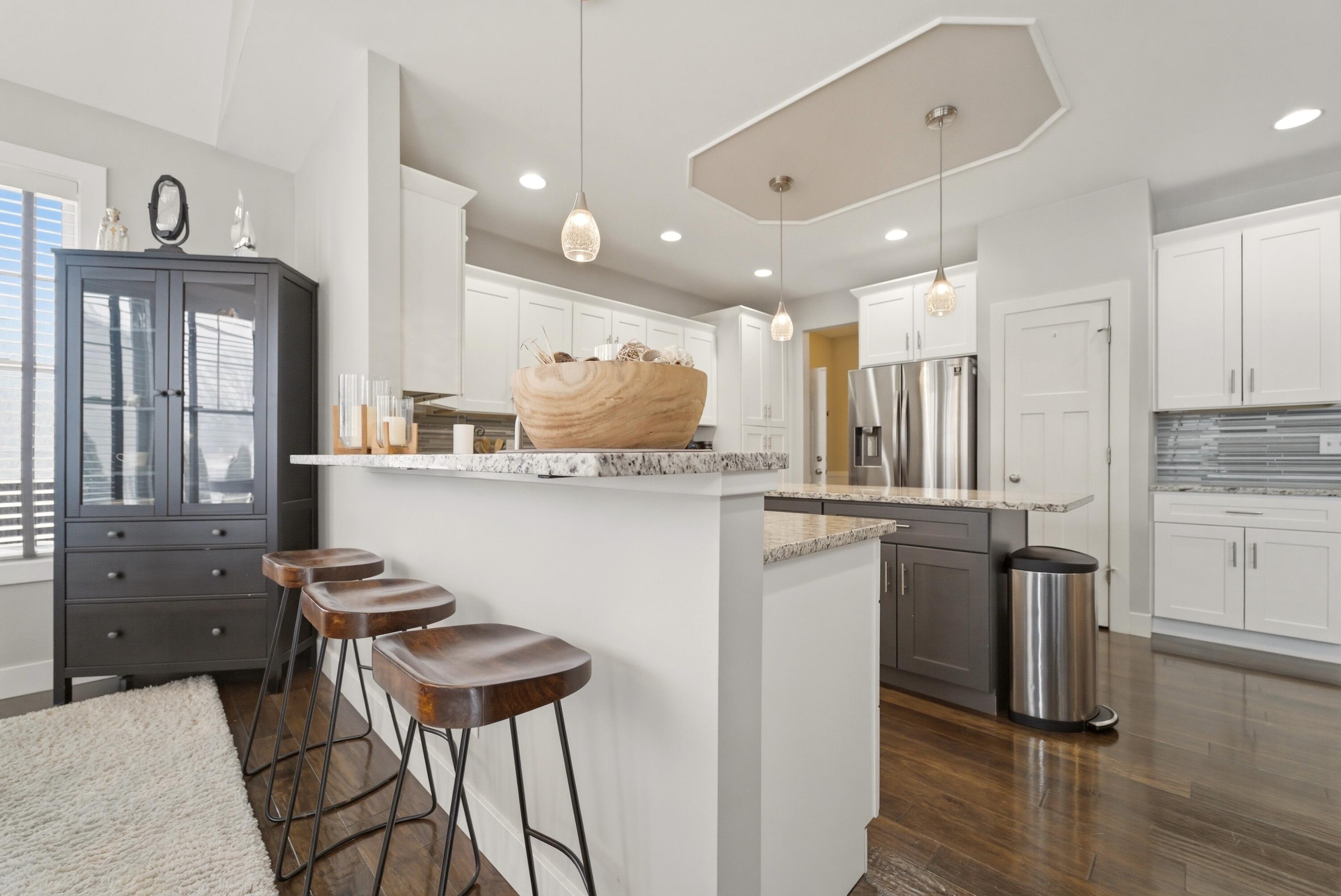 2102 Pradera Trail Chesterton, IN 46304 - Photo 20 of 50 a kitchen with kitchen island granite countertop a sink cabinets and stainless steel appliances