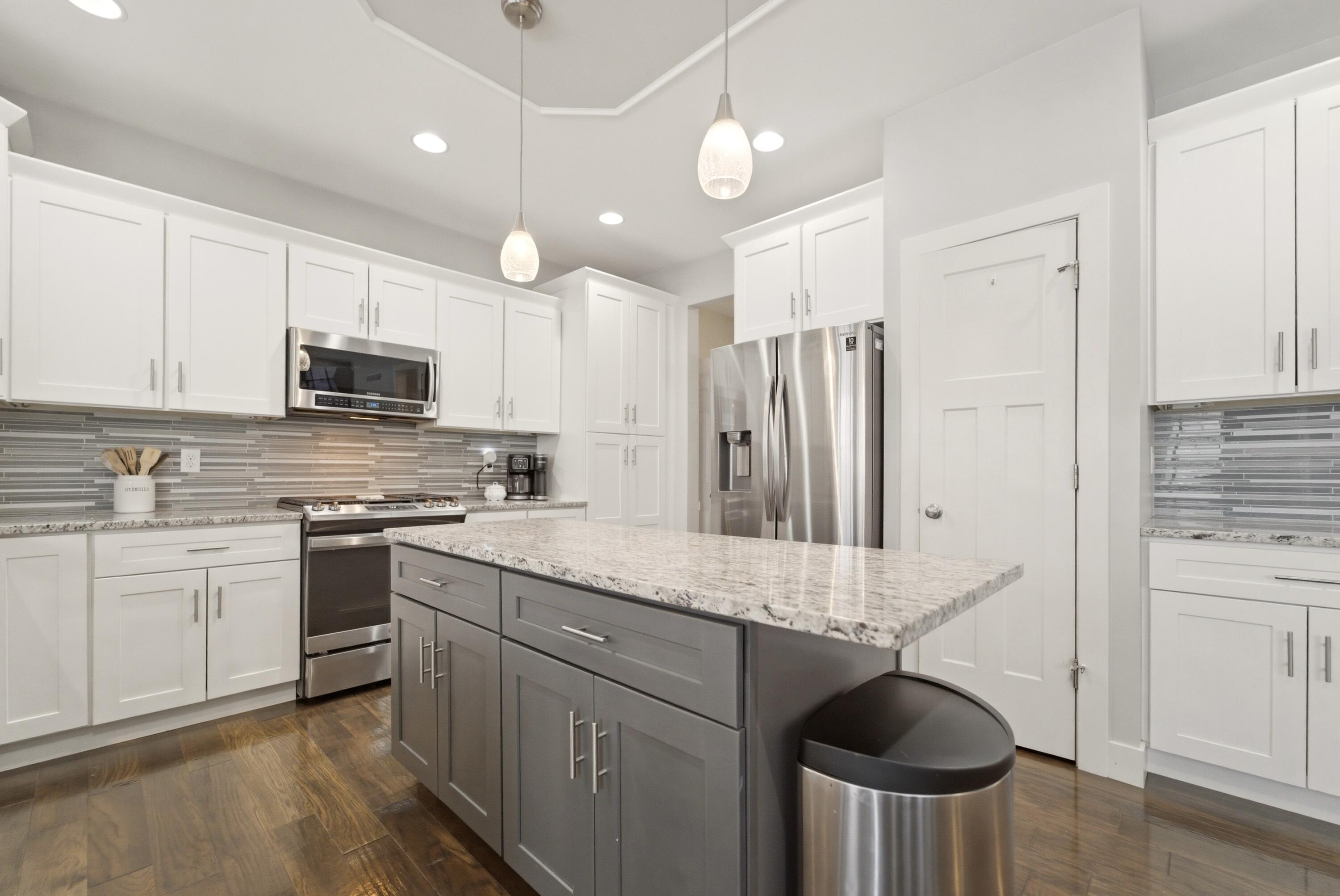 2102 Pradera Trail Chesterton, IN 46304 - Photo 21 of 50 a kitchen with stainless steel appliances granite countertop a sink a stove a refrigerator cabinets and chairs