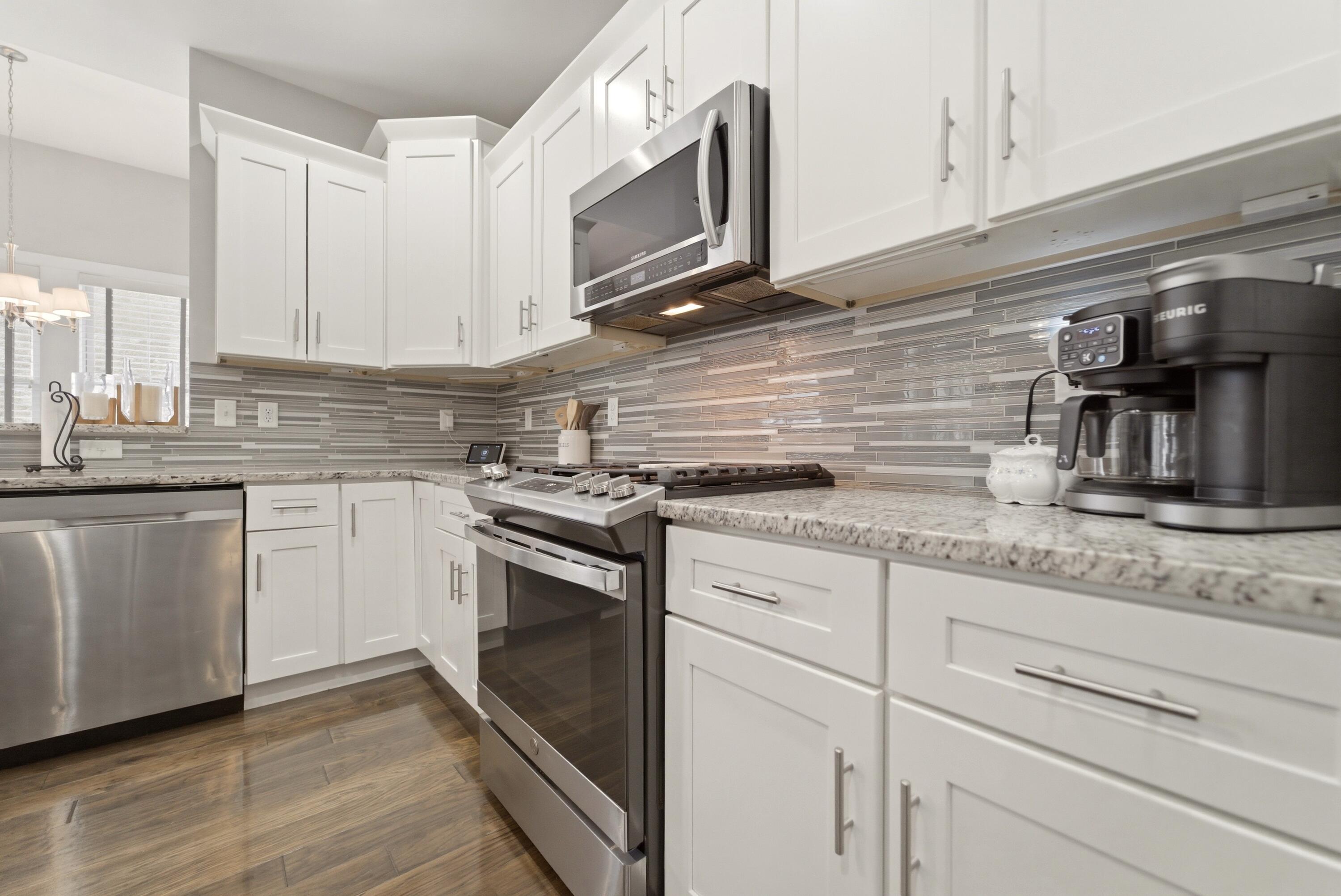 2102 Pradera Trail Chesterton, IN 46304 - Photo 24 of 50 a kitchen with granite countertop white cabinets stainless steel appliances and a sink