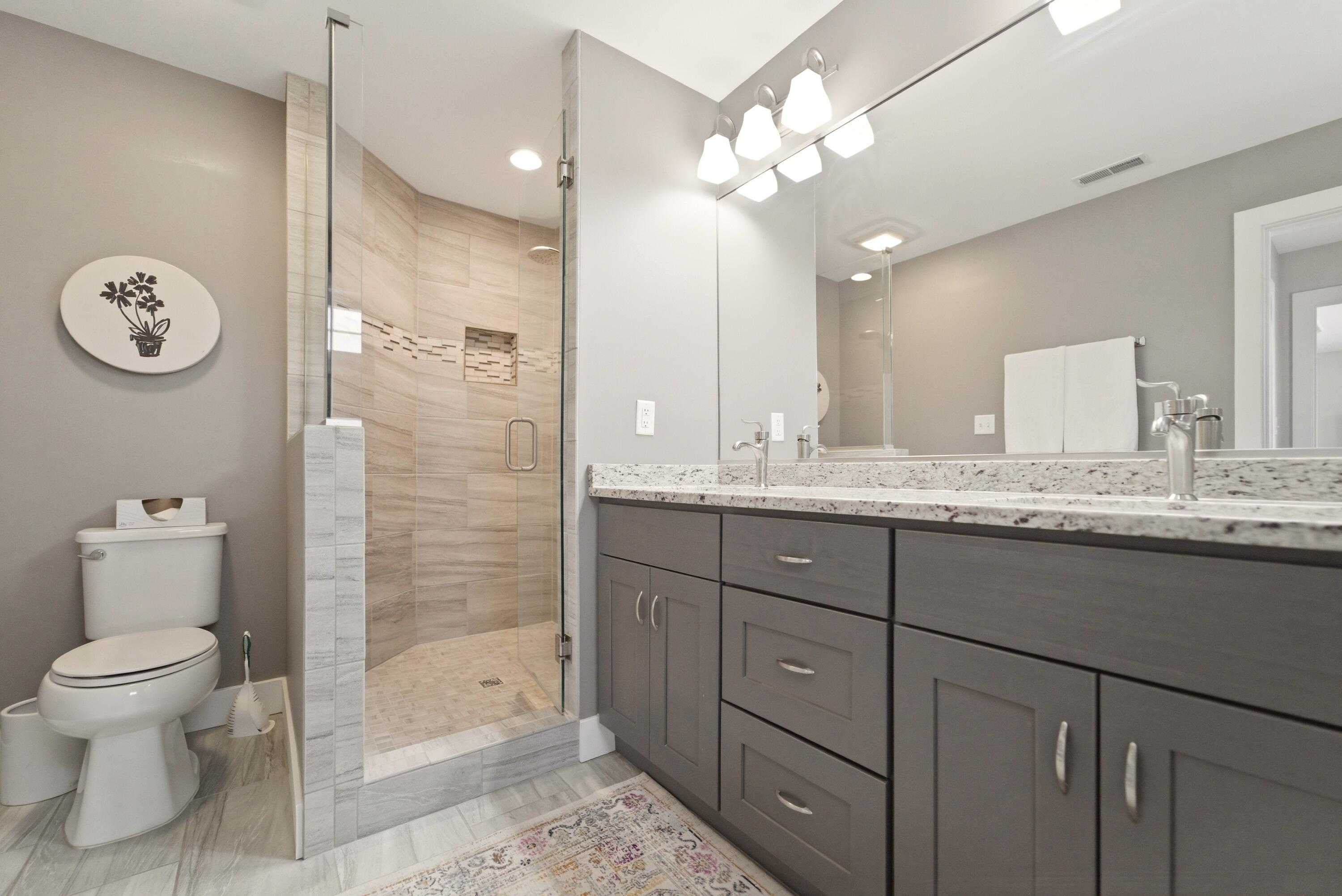 2102 Pradera Trail Chesterton, IN 46304 - Photo 40 of 50 a bathroom with a granite countertop sink a toilet and a mirror