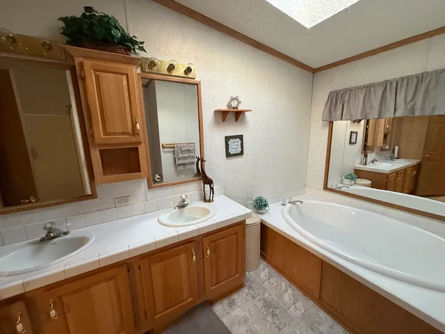 a bathroom with a double vanity sink and a bathtub