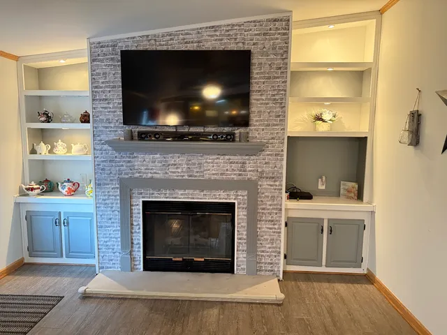 a living room with a flat screen tv and a fireplace