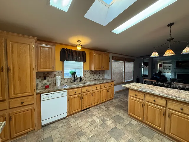 a kitchen with stainless steel appliances granite countertop a sink and cabinets