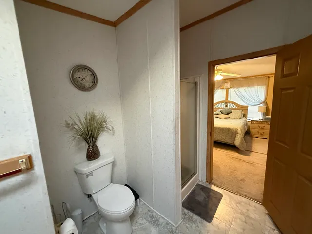 a bathroom with a toilet and a shower