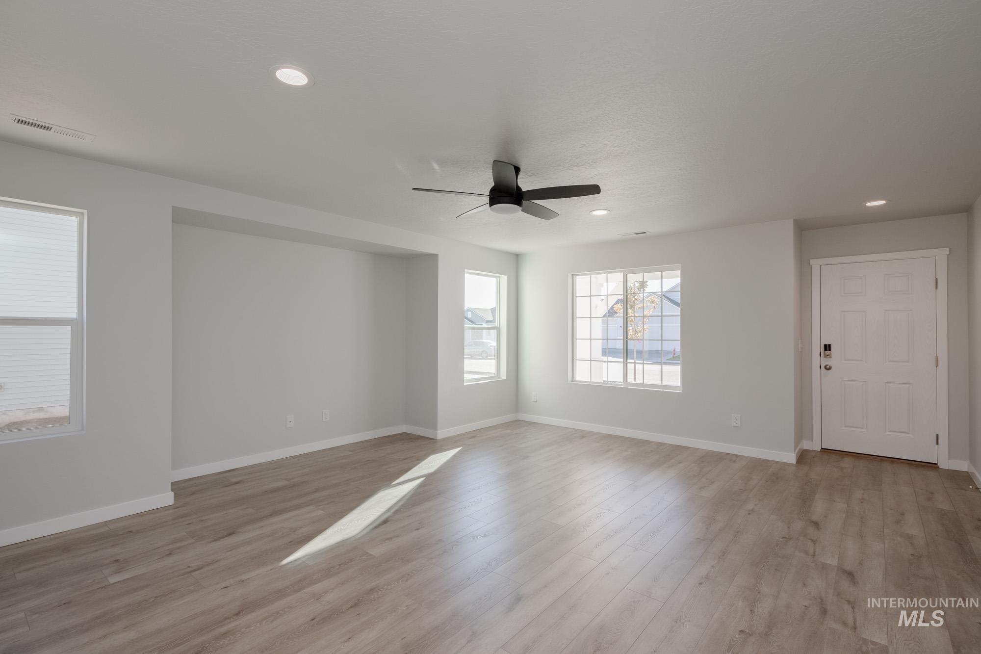 1732 Webb Brk Street Middleton, ID 83644 - Photo 15 of 29 Empty room with light wood-style flooring, recessed lighting, and ceiling fan