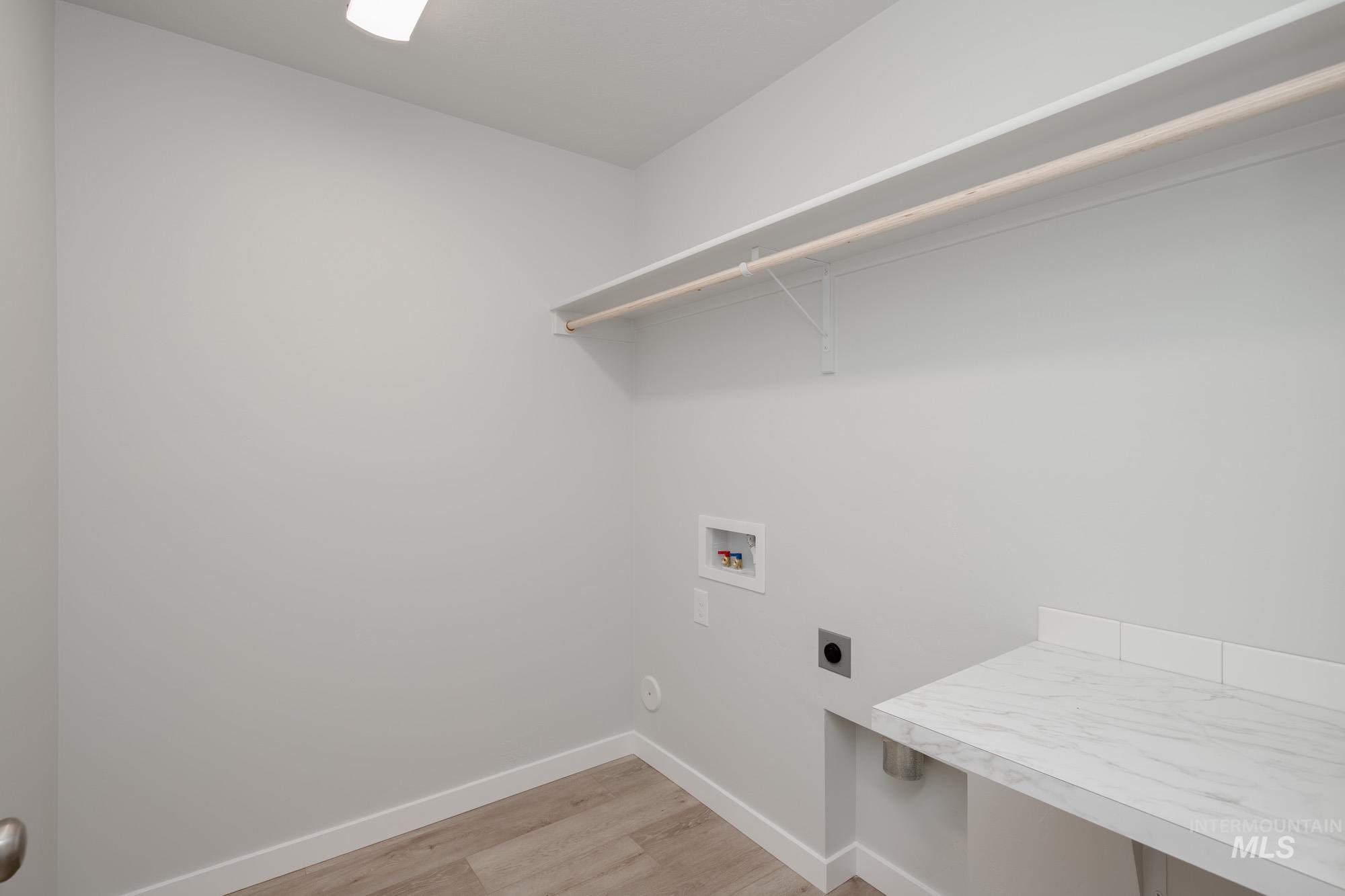 1732 Webb Brk Street Middleton, ID 83644 - Photo 17 of 29 Washroom with light wood-style floors, hookup for an electric dryer, and hookup for a washing machine
