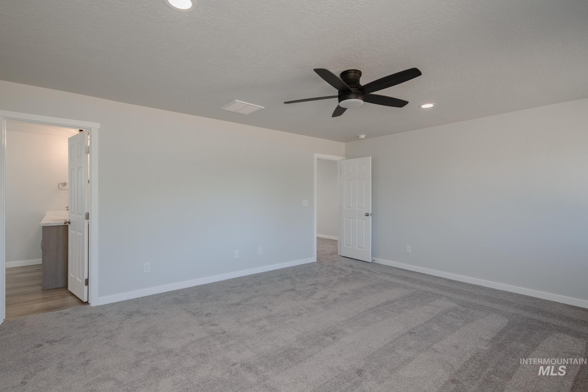 1732 Webb Brk Street Middleton, ID 83644 - Photo 25 of 29 Unfurnished bedroom featuring light carpet, a ceiling fan, recessed lighting, ensuite bath, and a textured ceiling