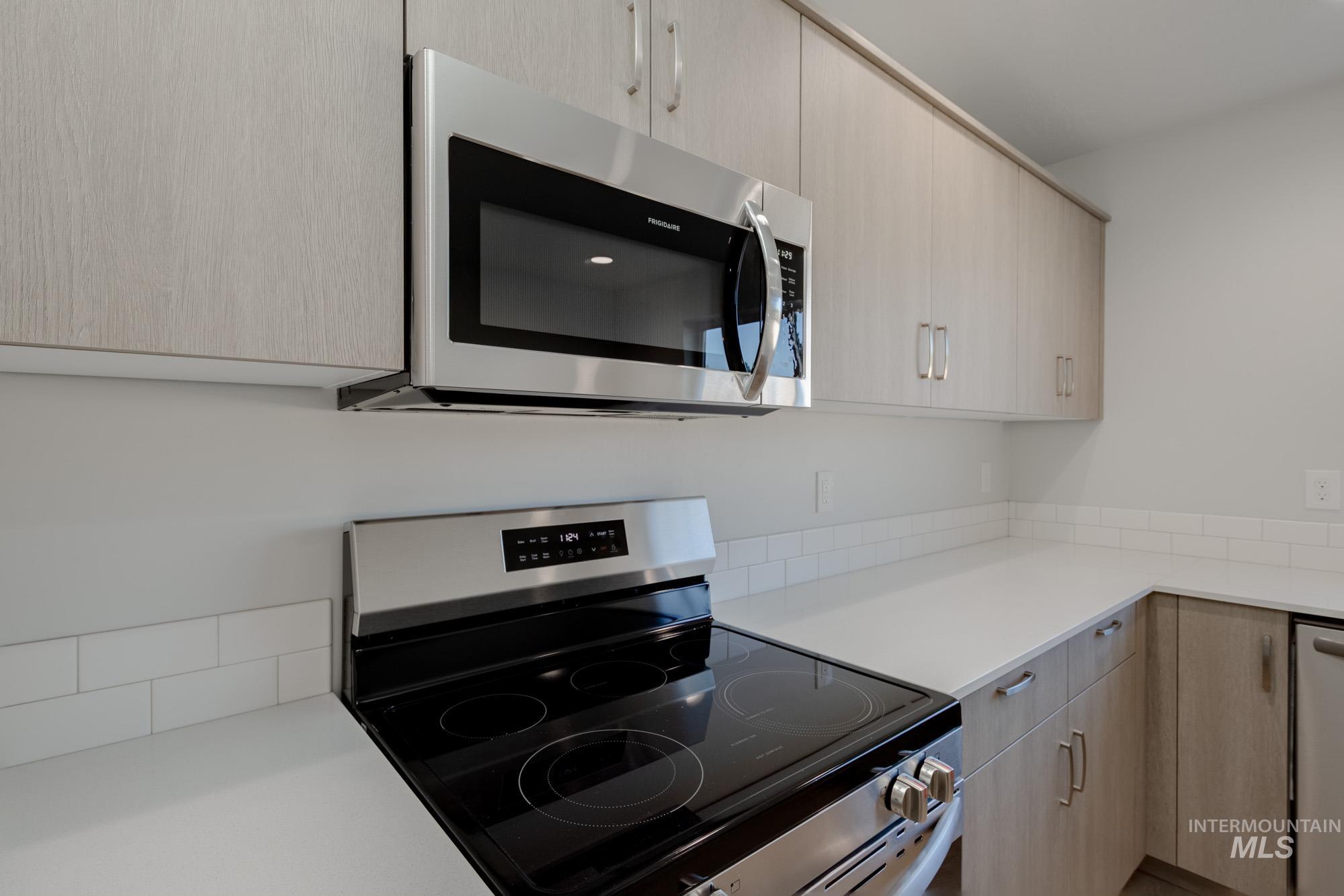 1732 Webb Brk Street Middleton, ID 83644 - Photo 6 of 29 Kitchen with light brown cabinetry, stainless steel appliances, and modern cabinets