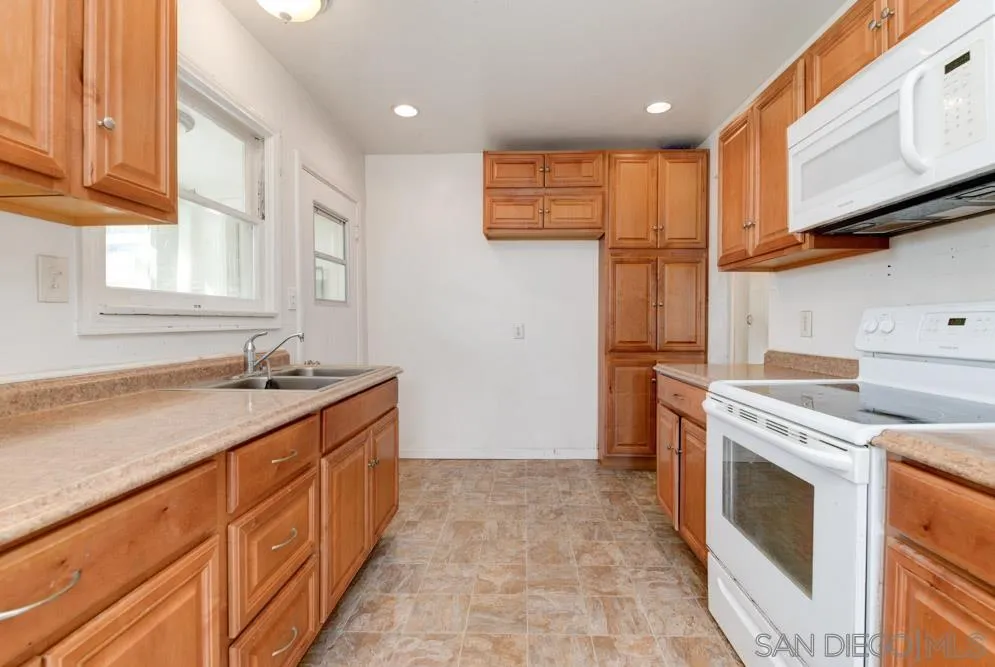 8941 Switzer Drive Spring Valley, CA 91977 - Photo 1 of 23 a kitchen with stainless steel appliances granite countertop a stove a sink and a refrigerator