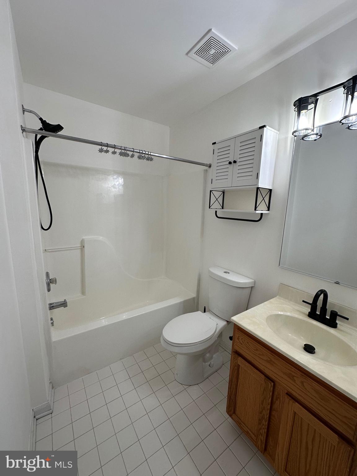 932 12th Street Pasadena, MD 21122 - Photo 13 of 14 a bathroom with a sink a toilet and shower