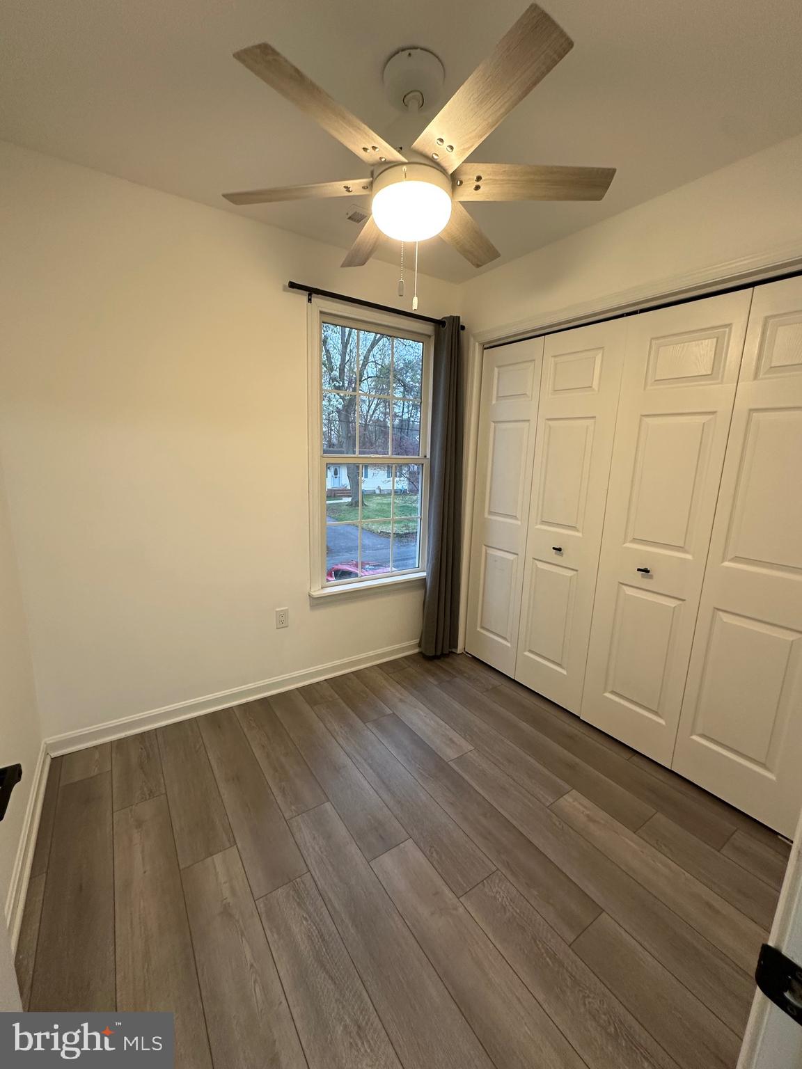 932 12th Street Pasadena, MD 21122 - Photo 9 of 14 wooden floor in an empty room with a window