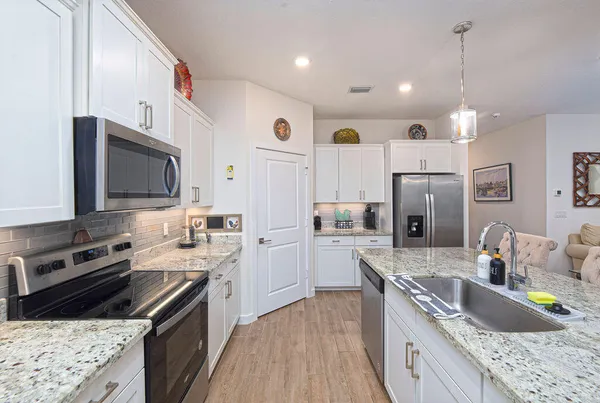 a bathroom with a granite countertop shower mirror and a toilet