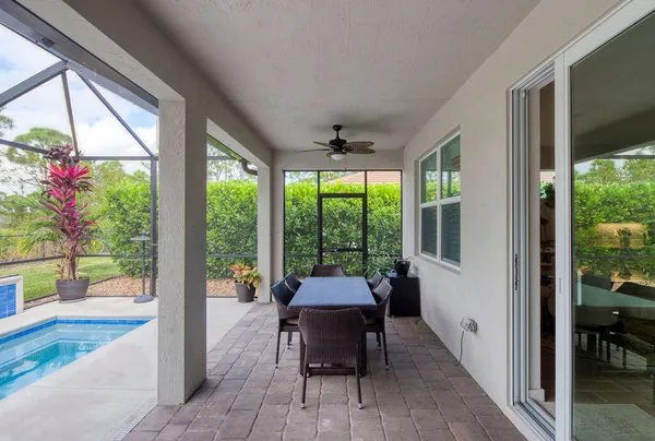 a view of a house with backyard and sitting area
