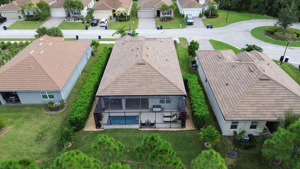 an aerial view of a house with garden space and street view