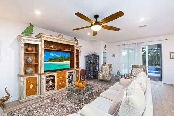 a living room with furniture a rug and a flat screen tv