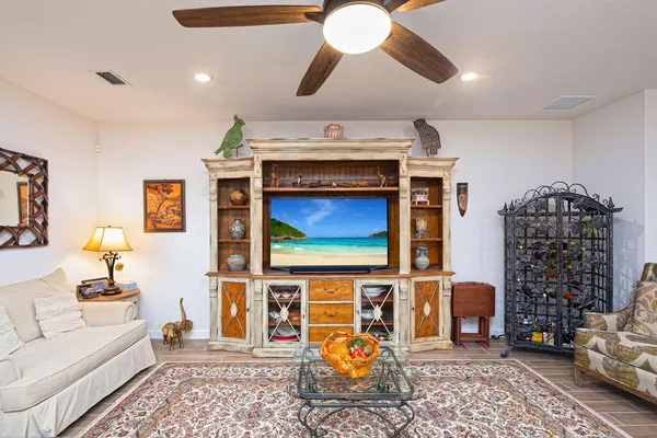 a living room with furniture a flat screen tv and rug