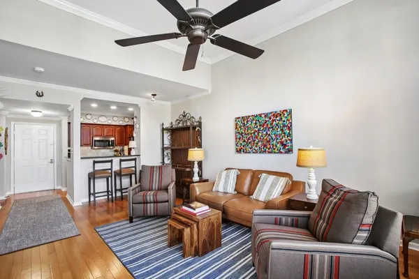 a living room with furniture and a wooden floor
