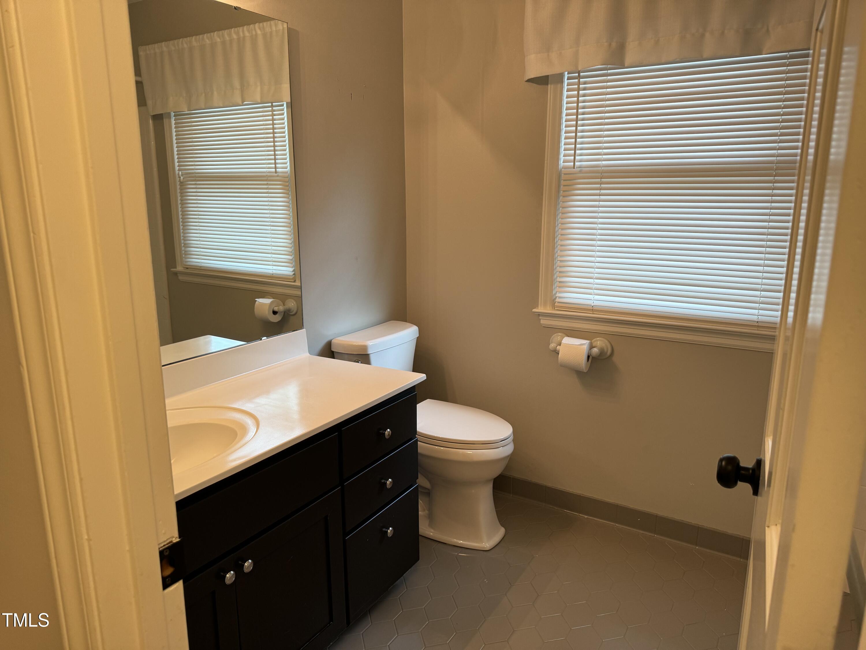 2501 Ferguson Road Raleigh, NC 27612 - Photo 18 of 30 a bathroom with a sink a toilet and shower