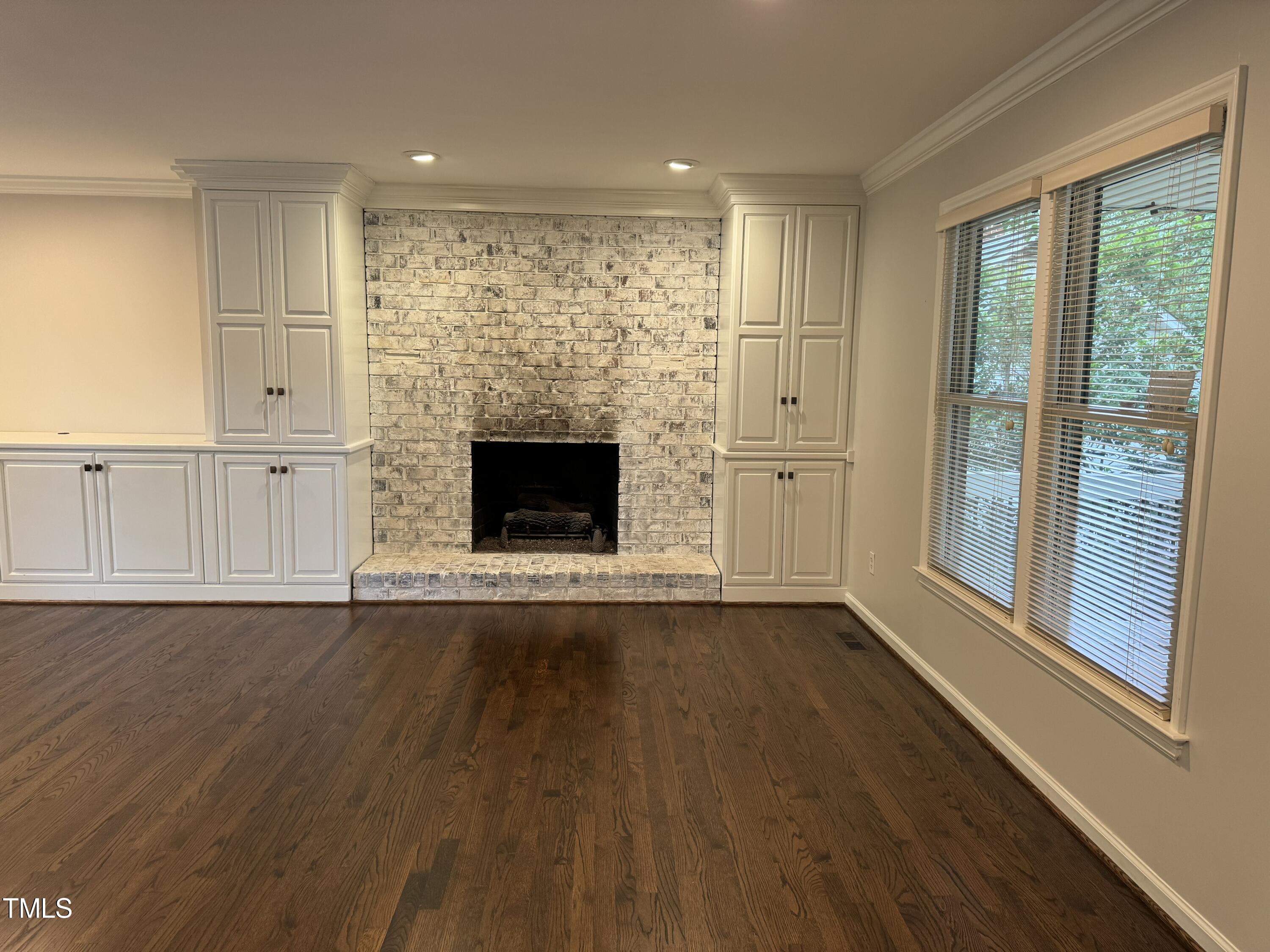 2501 Ferguson Road Raleigh, NC 27612 - Photo 5 of 30 a view of an empty room with wooden floor and a window
