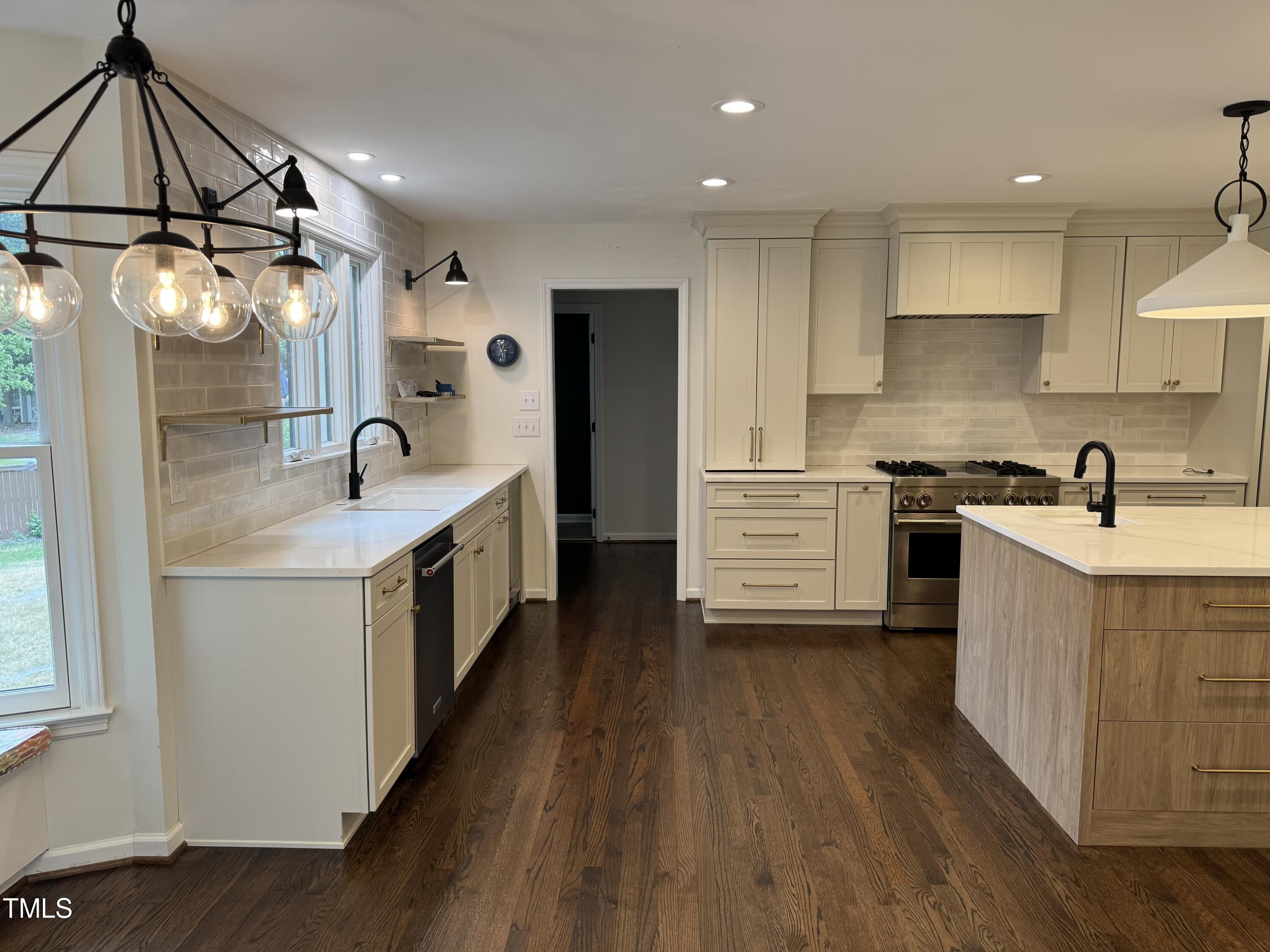 2501 Ferguson Road Raleigh, NC 27612 - Photo 6 of 30 a kitchen with a sink cabinets stainless steel appliances and wooden floor
