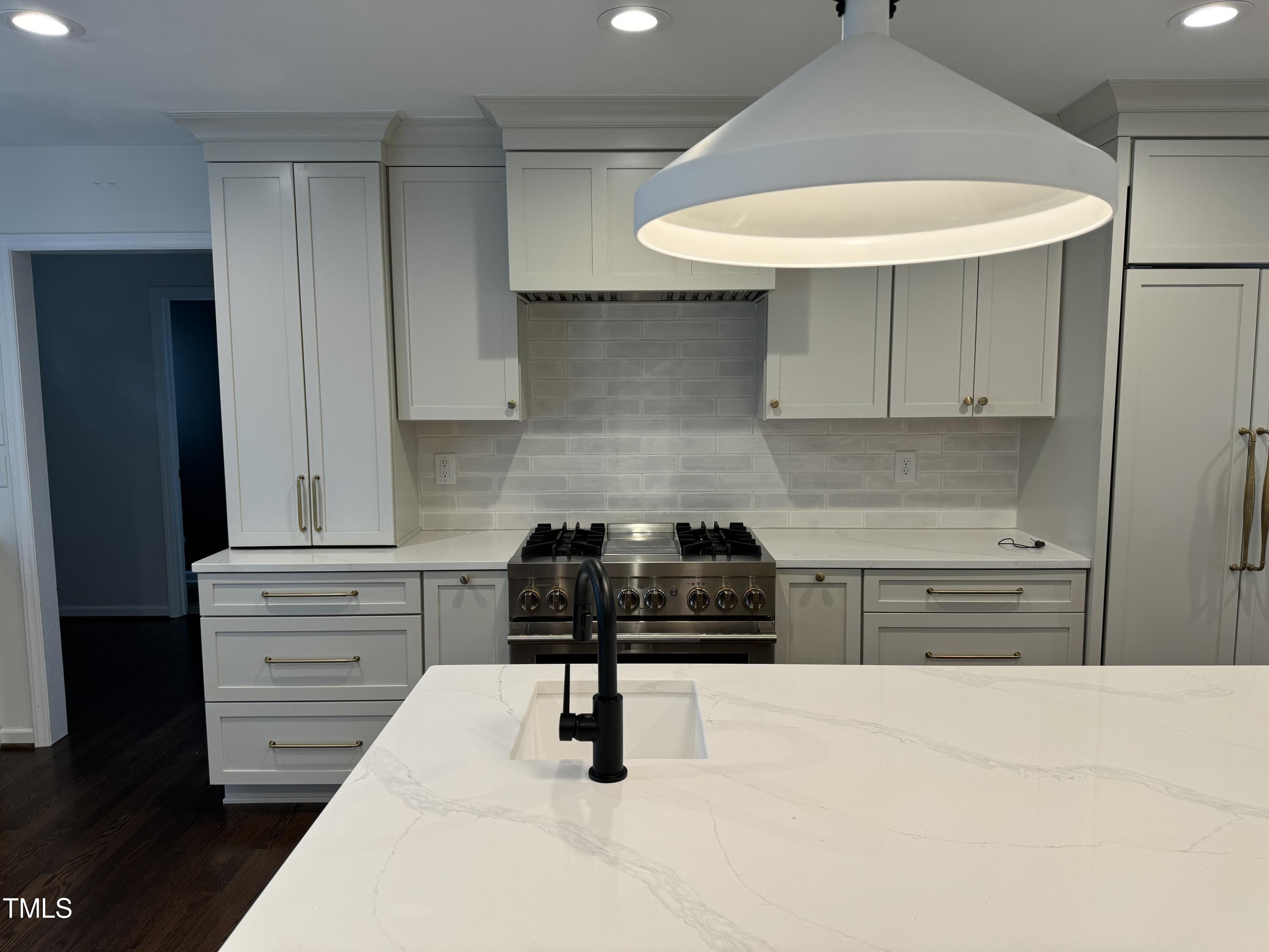 2501 Ferguson Road Raleigh, NC 27612 - Photo 9 of 30 a kitchen with a stove a refrigerator and cabinets