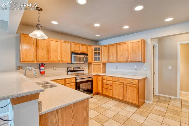 a kitchen with stainless steel appliances granite countertop a sink and cabinets